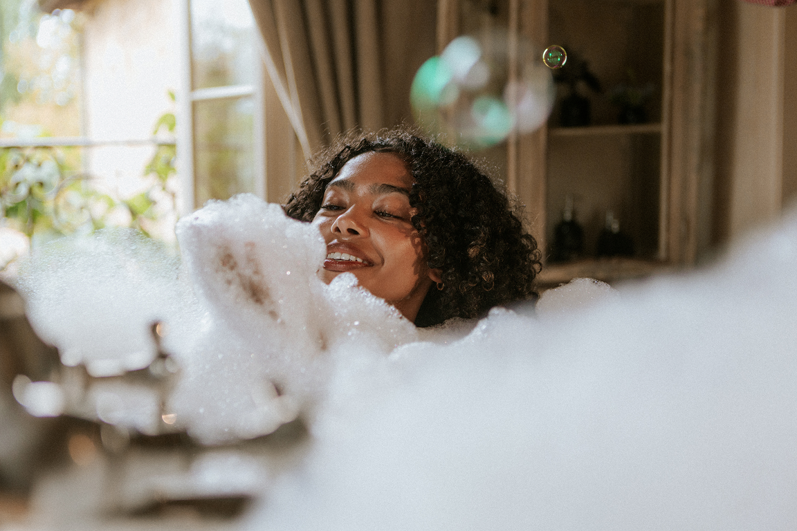 Woman relaxing in a bubble bath